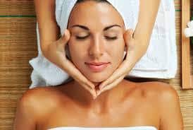 A woman enjoying a relaxing facial massage at a spa, perfect for Holiday Specials and Massage Gift Certificates.