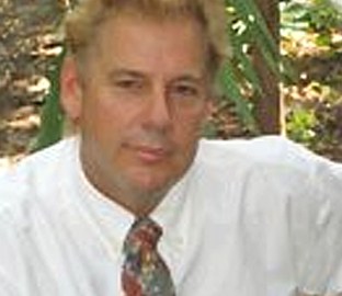 Mark Lohmann LMT, a man wearing a white shirt and tie, is a skilled massage therapist.